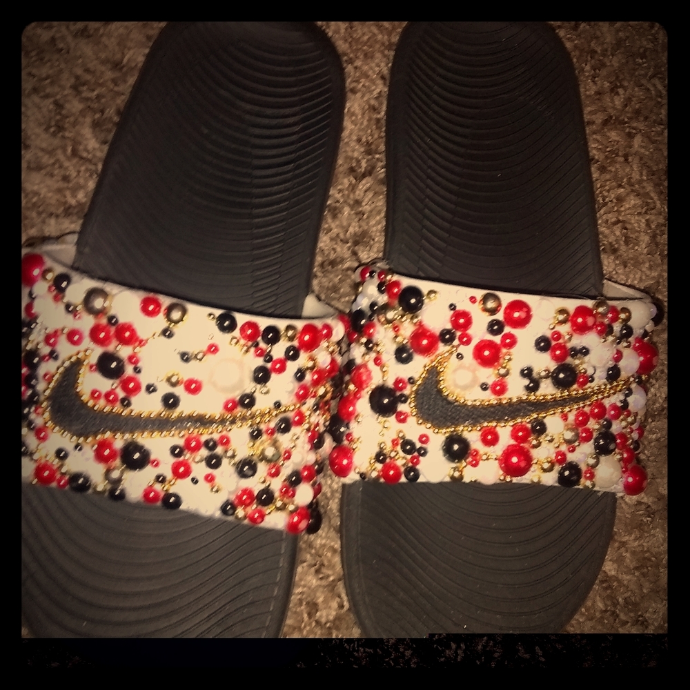 Custom red black and white Nike slides.